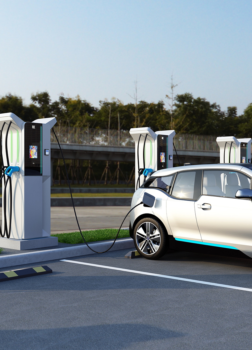 Electric vehicle charging at a commercial DC fast charging station, with multiple chargers installed nearby, showcasing scalable EV charging solutions for businesses