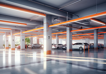 Bright underground parking garage with neatly parked cars and EV charging stations for workplace convenience.