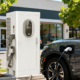 Commercial Level 3 DC fast charging station powering an electric vehicle in a parking lot