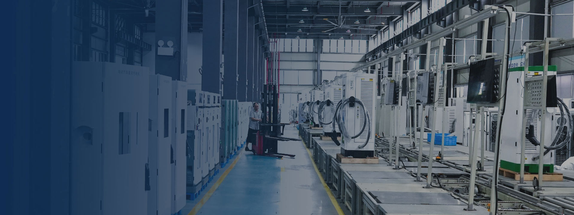 Technicians assembling EV chargers on the production line, installing wiring harnesses and electronic components in a modern factory