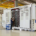 engineers inspecting 5MWh liquid-cooled BESS container in factory, battery energy storage system testing and quality assurance before deployment