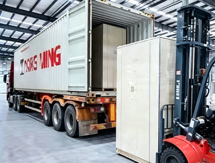 forklift loading battery energy storage container into transport truck for delivery