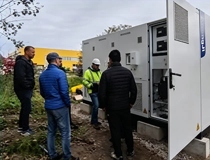 engineers performing commissioning and final testing of battery energy storage system before delivery
