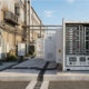 An outdoor integrated commercial ESS solution featuring a secure weatherized enclosure with Grade-A LFP lithium ion battery storage modules.