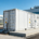 A containerized BESS system integrated into an industrial ESS solution for a modern factory.