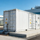 A containerized BESS system integrated into an industrial ESS solution for a modern factory.