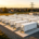 A large-scale battery storage plant featuring multiple BESS containers connected to the power grid for utility energy storage.