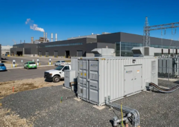 A high-capacity 1MW battery storage system for manufacturing plants installed on a concrete foundation next to a factory substation.