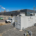 A high-capacity 1MW battery storage system for manufacturing plants installed on a concrete foundation next to a factory substation.