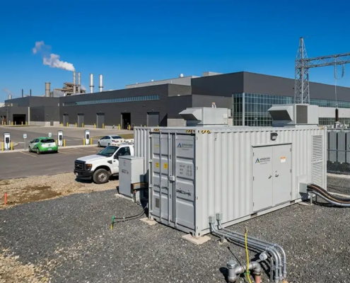 A high-capacity 1MW battery storage system for manufacturing plants installed on a concrete foundation next to a factory substation.