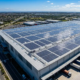 A massive industrial warehouse rooftop utilizing turnkey solar EPC services with hundreds of premium solar panels installed.