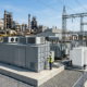 Turnkey containerized 1MW battery storage solutions installed on a concrete foundation at a commercial industrial facility for facility peak shaving.