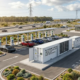 An industrial battery energy storage system for EV charging stations installed next to high-power DC fast dispensers.