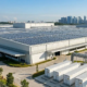 Implementing an integrated project delivery model featuring rooftop solar arrays and commercial battery storage containers.