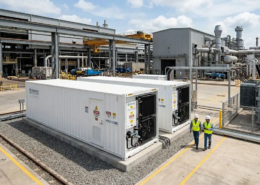 High-capacity industrial bess containerized system installed next to a manufacturing plant for energy cost reduction.