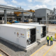 High-capacity industrial bess containerized system installed next to a manufacturing plant for energy cost reduction.