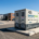 A turnkey 1MW commercial battery storage system container deployed at a manufacturing facility for peak shaving and cost reduction.
