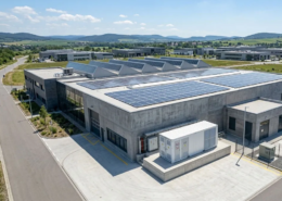 A complete turnkey battery energy storage system for sale installed next to a modern manufacturing facility.