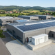 A complete turnkey commercial solar plus storage system cost investment featuring rooftop PV arrays and containerized LFP battery packs in Europe.