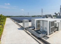 An integrated 20ft BESS container installed on a site foundation pad alongside solar PV panels for optimal commercial energy storage.