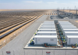 Aerial view of a large scale solar farm with single-axis tracking panels and high-voltage grid substation