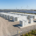 A secure containerized BESS installation integrated with renewable energy storage solutions on a modern utility site.
