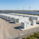 A secure containerized BESS installation integrated with renewable energy storage solutions on a modern utility site.