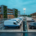 Commercial EV fleet charging solutions layout showing delivery vans charging overnight with Level 2 AC units alongside a dual-port DC fast charger at an industrial depot.