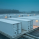 A grid-scale battery energy storage system facility manufactured in Germany during blue hour