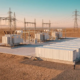 High-voltage grid scale battery storage system containers connected to a utility power grid substation