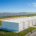 High-voltage grid scale battery storage system container array working beside a utility substation