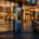 A sleek luxury electric vehicle charging at a hotel entrance EV station during dusk