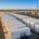 Utility-scale battery storage system containers connected to a high-voltage grid substation.