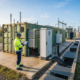 Engineer inspecting liquid-cooled battery racks inside a 5MWh BESS container