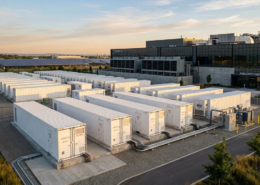 Large-scale battery energy storage system containers installed outside a modern data center with solar panels