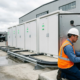 Commercial BESS grid connection showing liquid-cooled battery cabinets tied to a medium-voltage step-up transformer at an industrial facility
