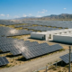 Large-scale solar farm with 40ft battery storage containers for a BESS EPC project