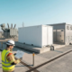 Black start BESS on concrete foundations beside an industrial substation during grid restoration planning