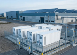 AC-coupled battery storage beside a European factory with rooftop solar PV